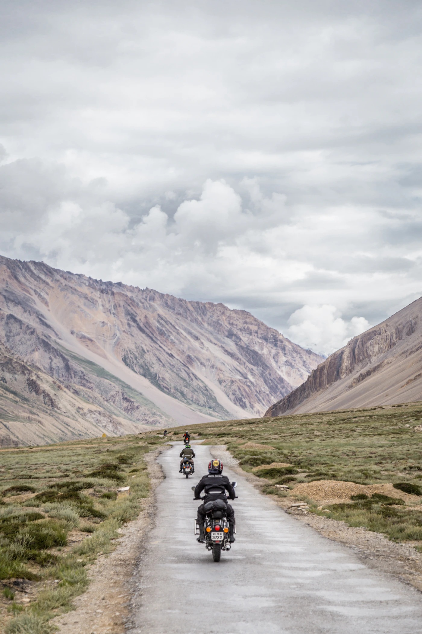 Motorcyclists following a road through a mountain valley